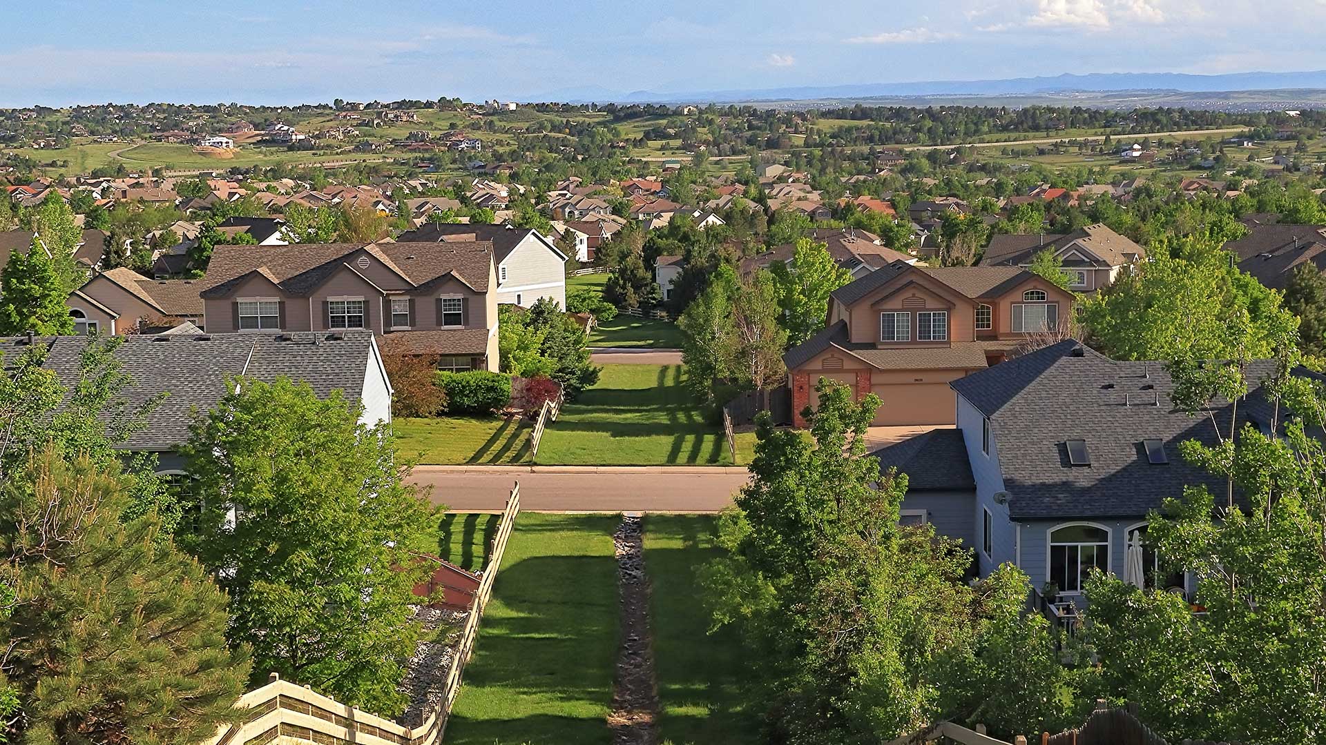 Aerial view of residential neighborhoods and open green spaces in Centennial, Colorado near The Wright apartments.