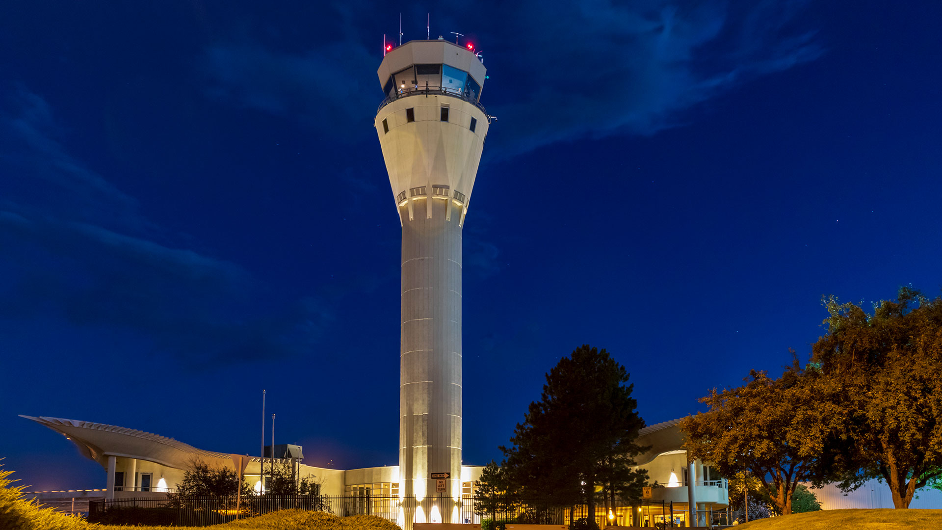 Centennial Airport air traffic control tower illuminated at night in Centennial, Colorado, near The Wright apartments.
